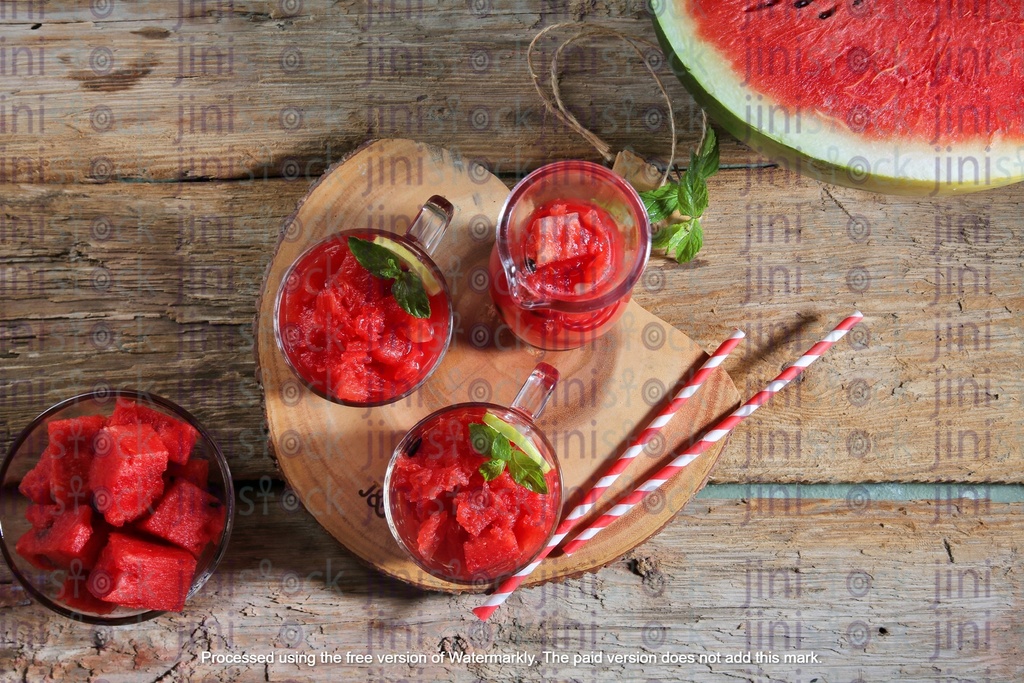 Two glasses of watermelon juice with mint and lemon