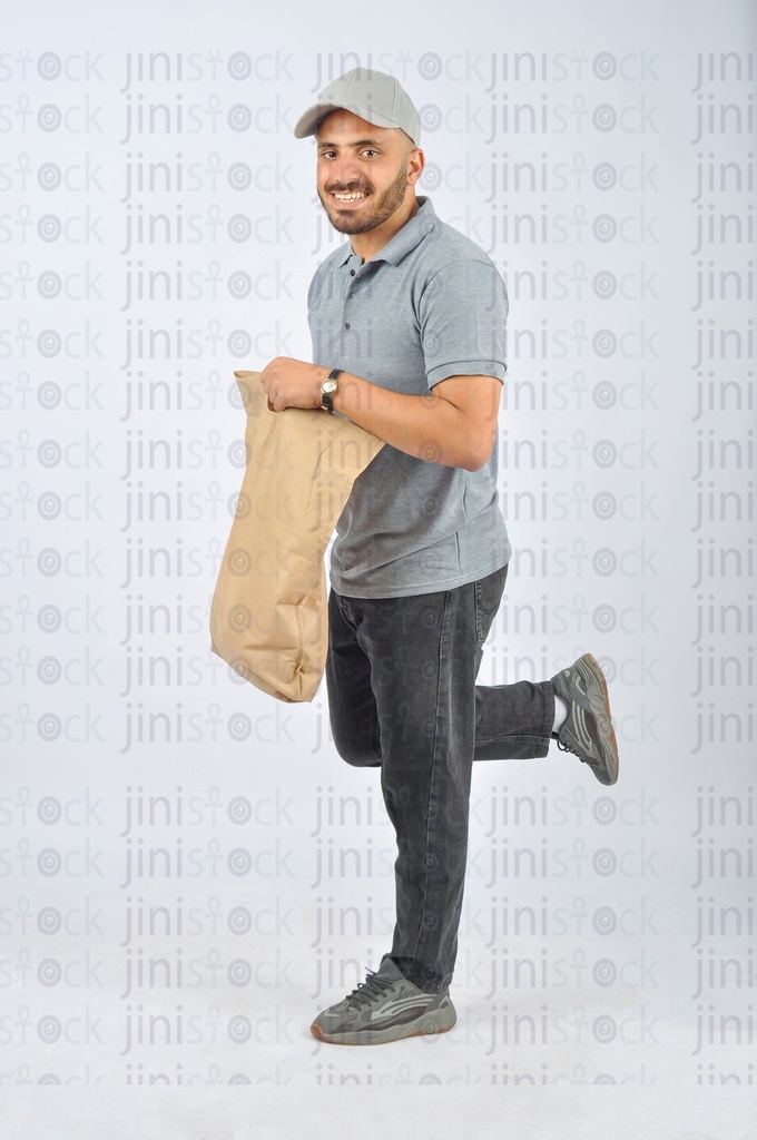 A delivery man holding a sack and running