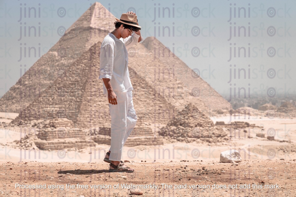 tourist wearing hat standing infront of the pyramids