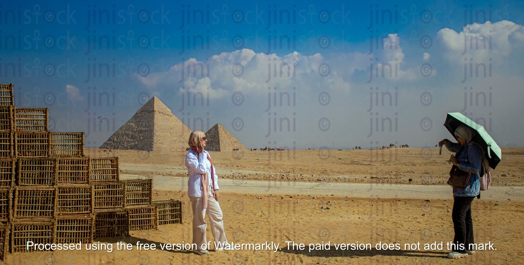 girl taking pictures infront of the pyramids