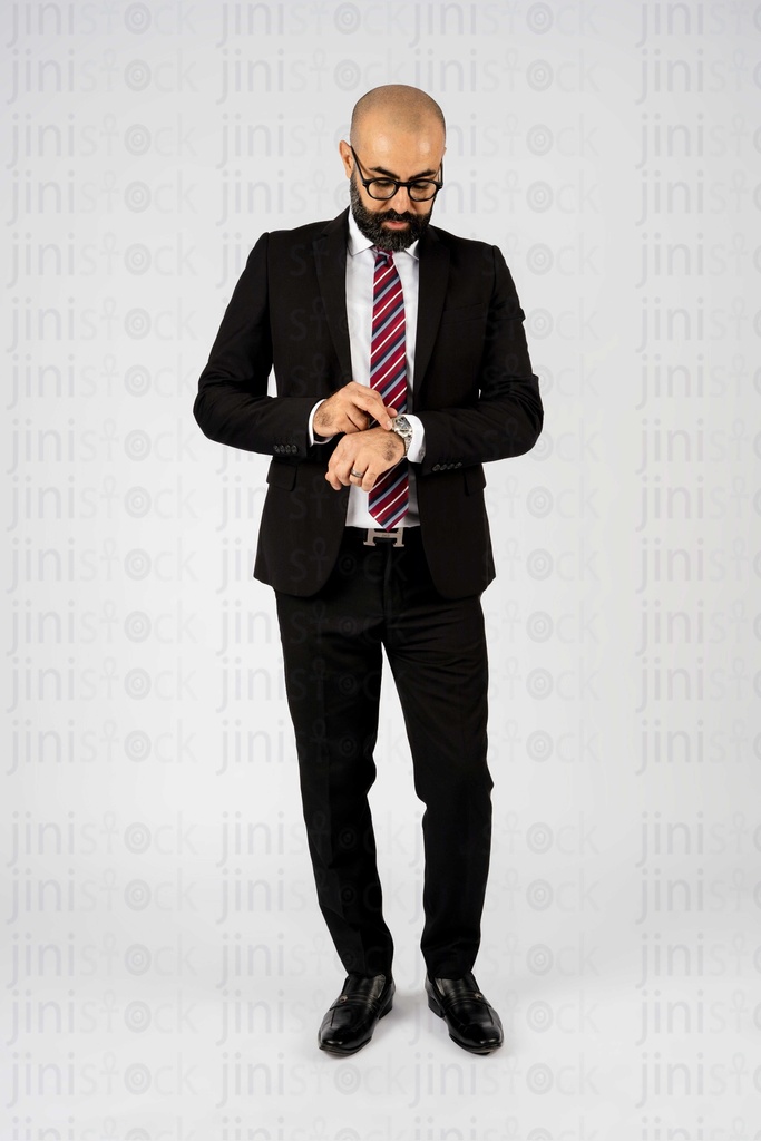 Businessman setting up his watch his clock