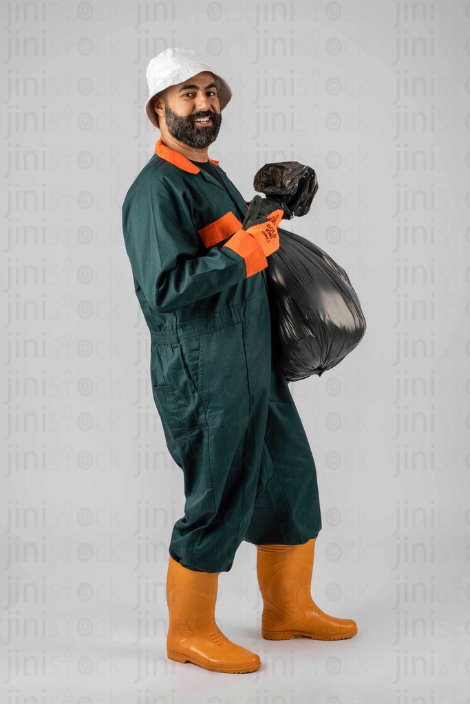 Smiling janitor holding a bag of garbage