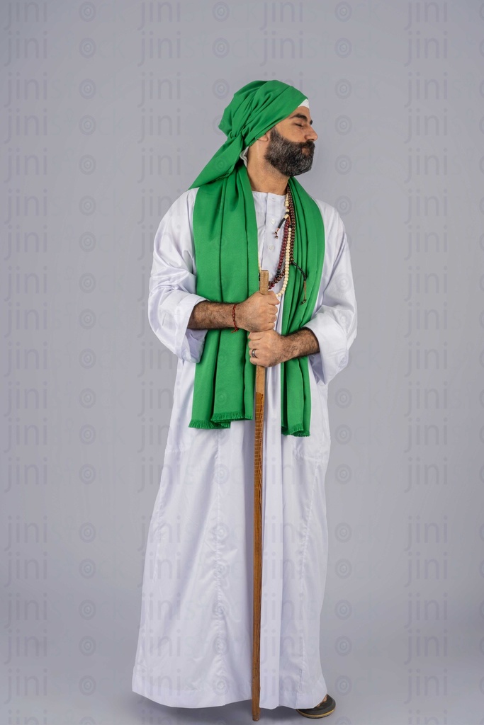 Egyptian wizard with green turban and shal holding a stick