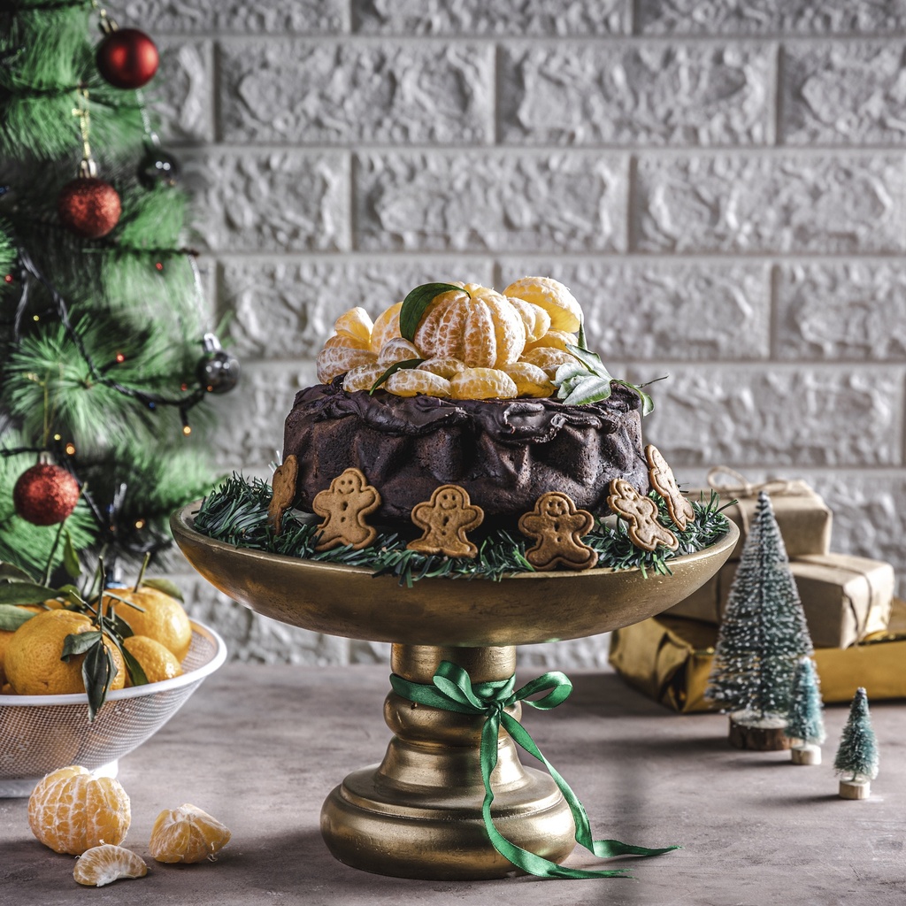 Chocolate round cake with tangerine in top