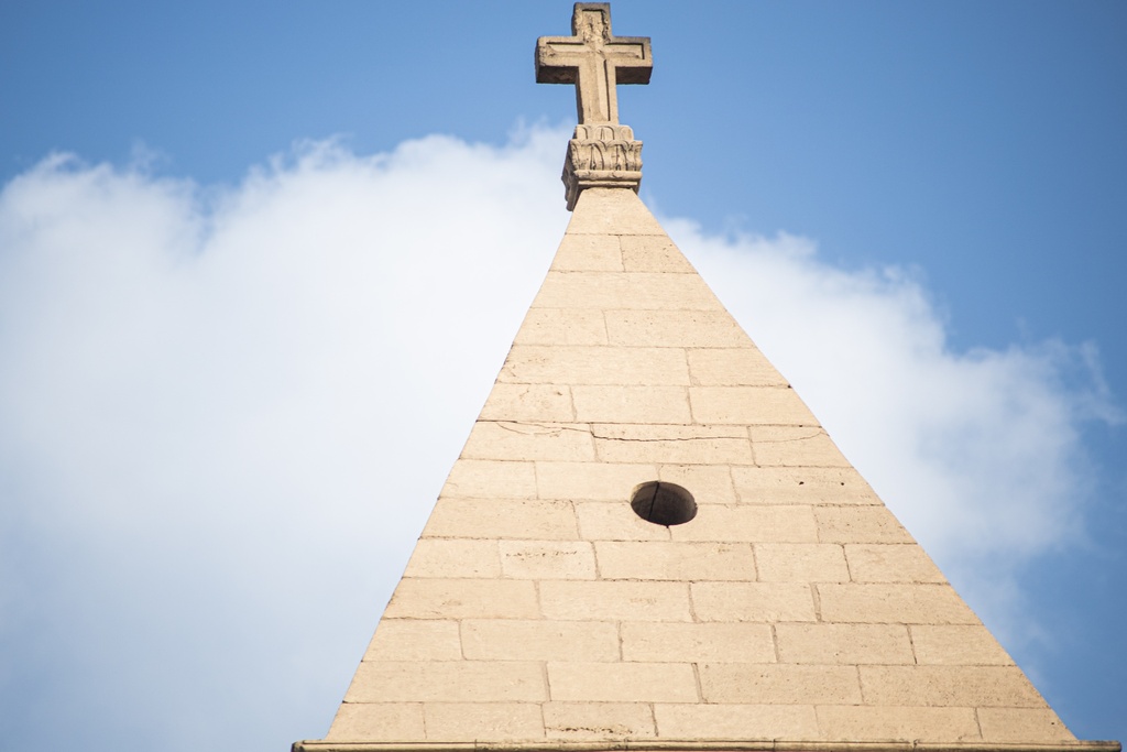 A church tower surmounted by a cross