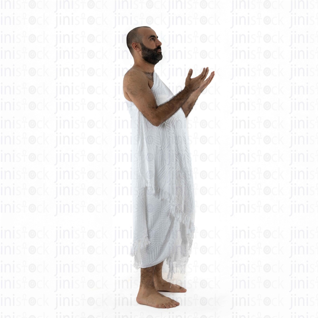 man praying in umrah outfit side view