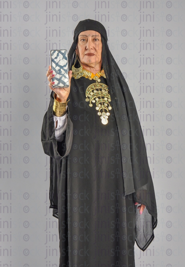 an upper Egypt woman holding a mobile phone recommending a mobile application