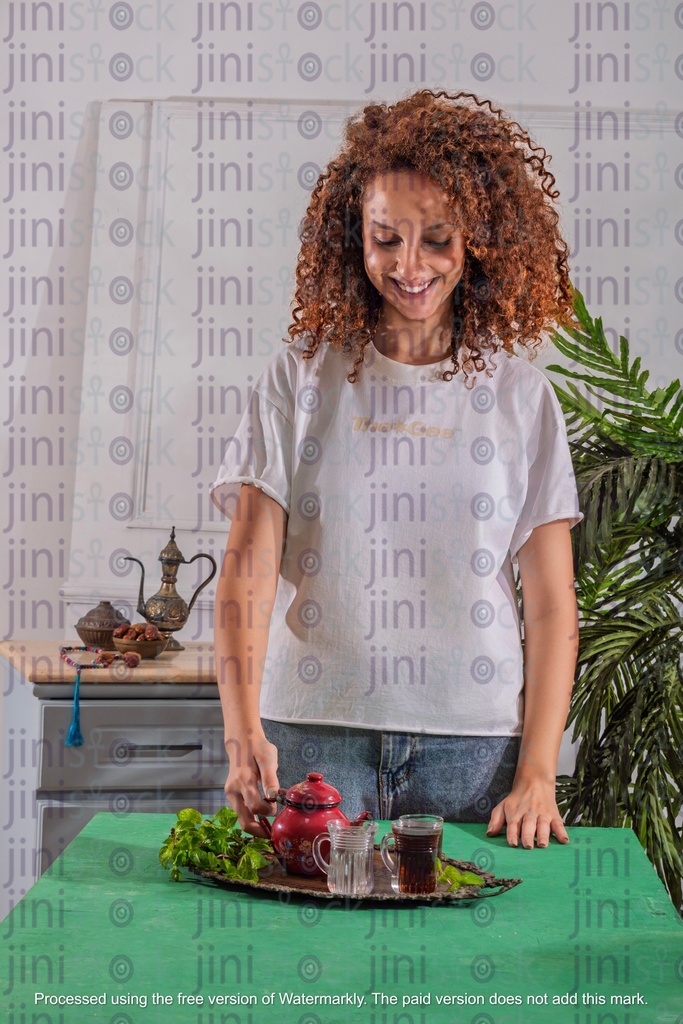 girl with curly hair holding tea pot