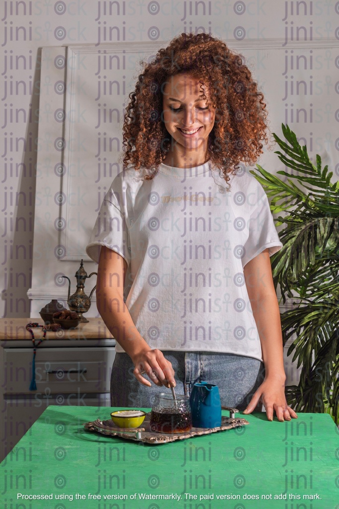 girl with curly hair stirring the tea