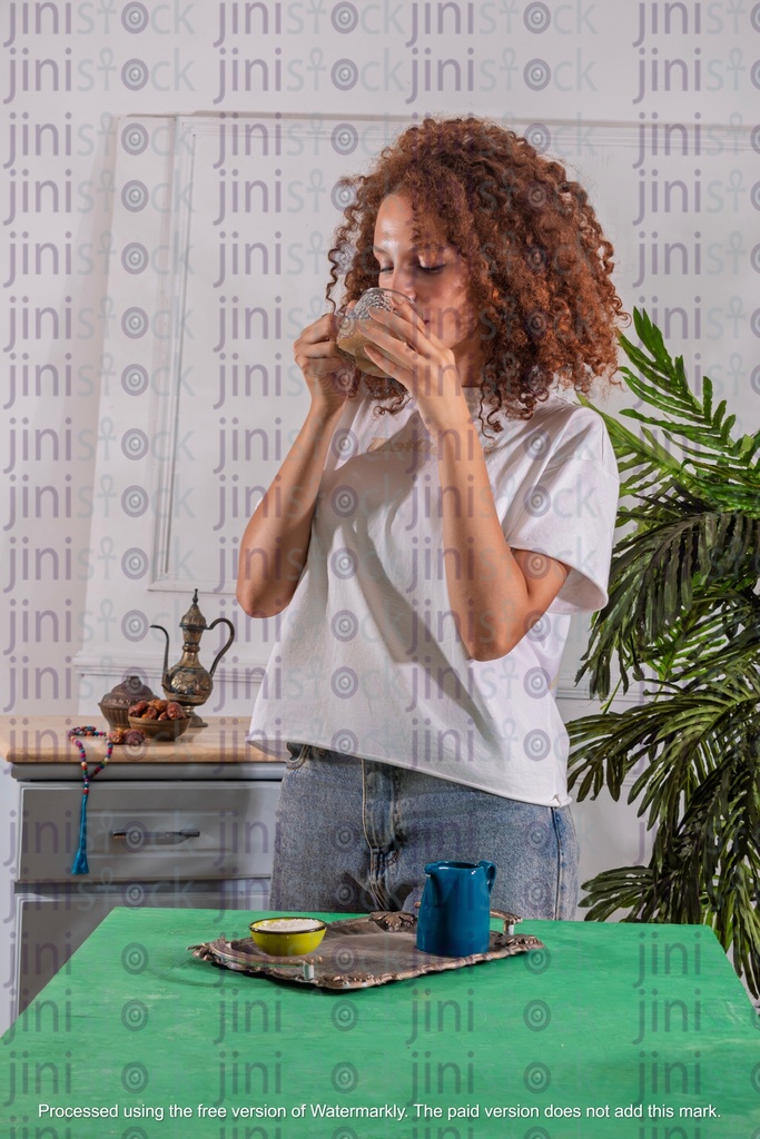 girl with curly hair drinking tea with milk