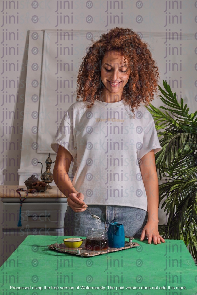 girl with curly hair adding sugar to the tea