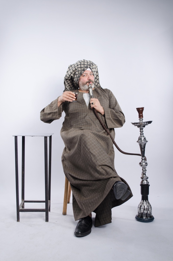 man in galabia drinking tea