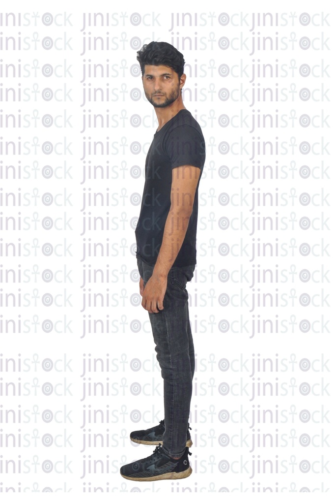 Slim egyptian young man standing side view and looking to the camera