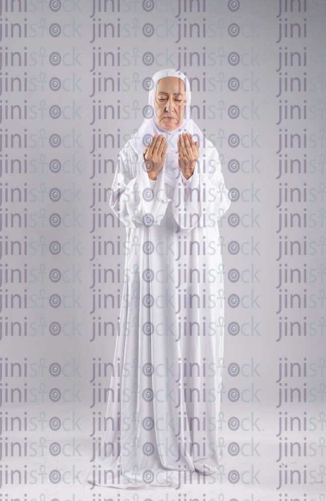 Old woman raising her hands for prayer