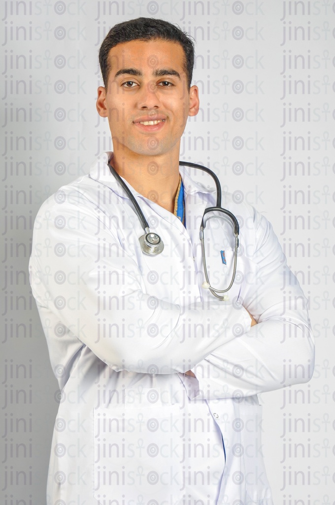 A male Egyptian doctor wearing a white coat and a stethoscope.