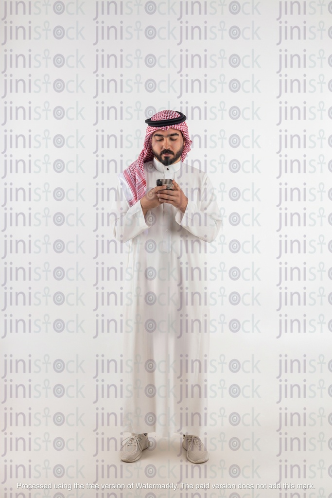 khaliji man looking at his phone