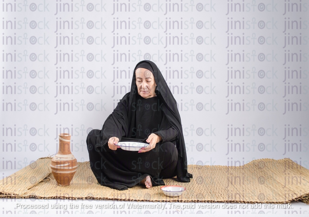 poor Egyptian woman sitting on the floor with no food