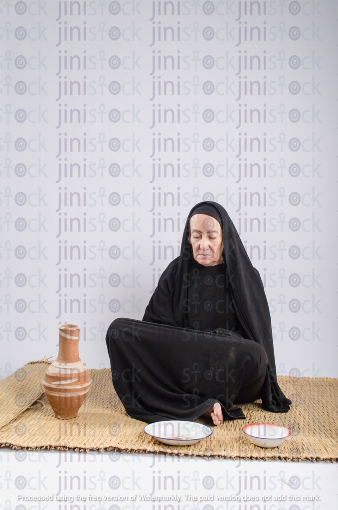 poor egyptian woman sitting on the floor