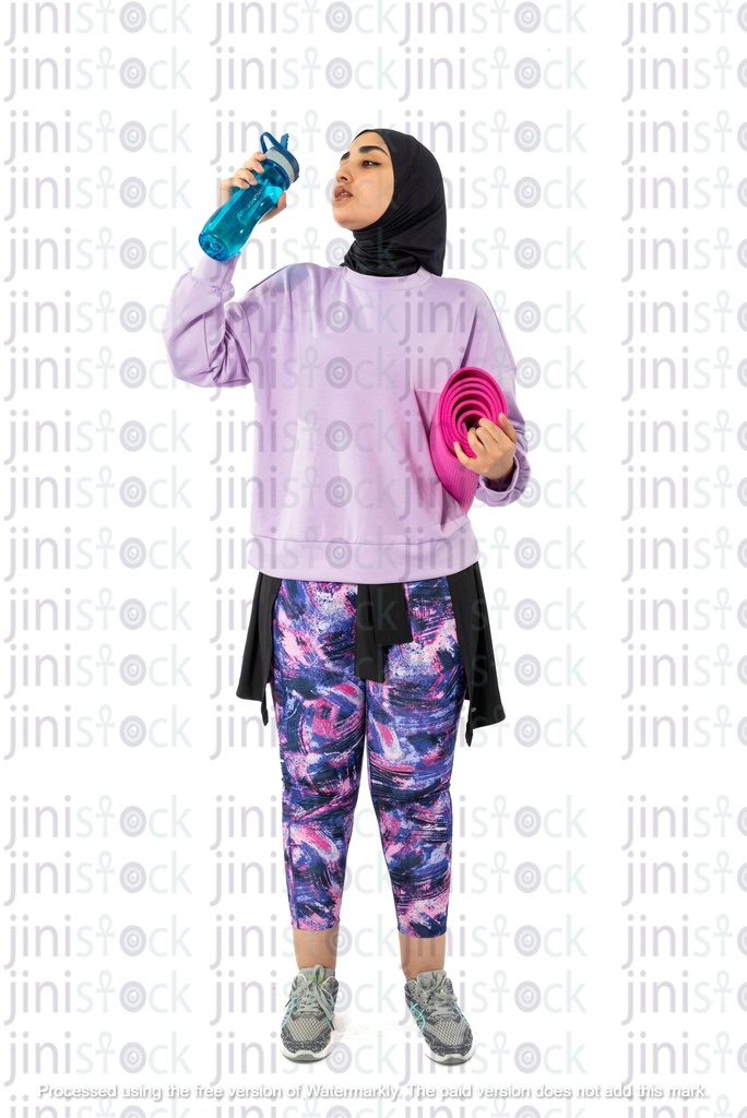 Egyptian girl wearing hijab drinking water while working out