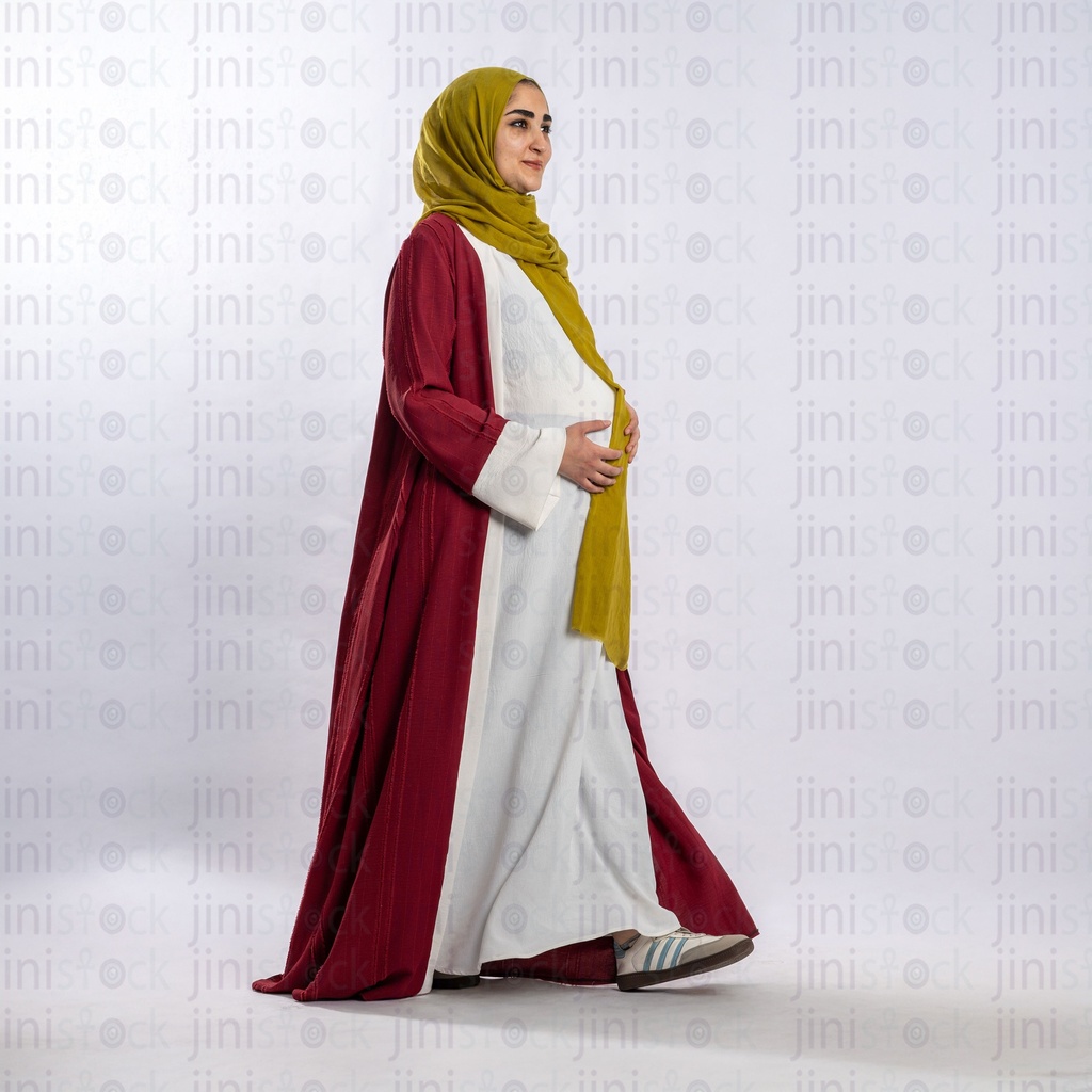 Arabian pregnant woman walking wearing hajb