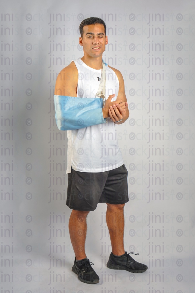 An athletic man with a broken hand or an arm injury.