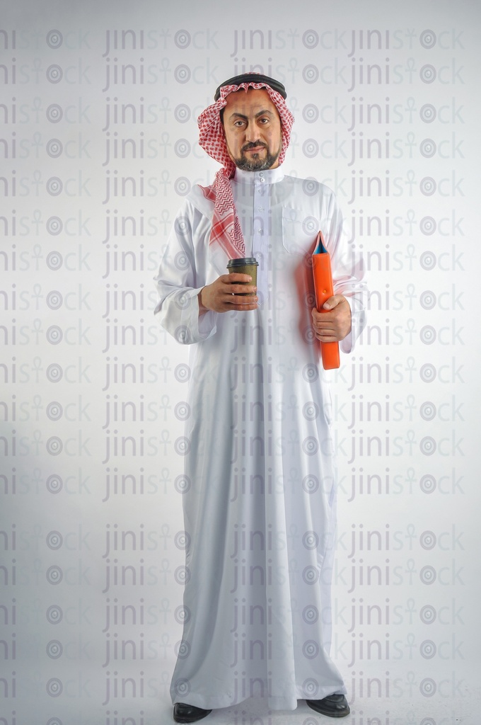 A man from gulf Saudi or Emirati holding a cup of coffee and a folder of work papers