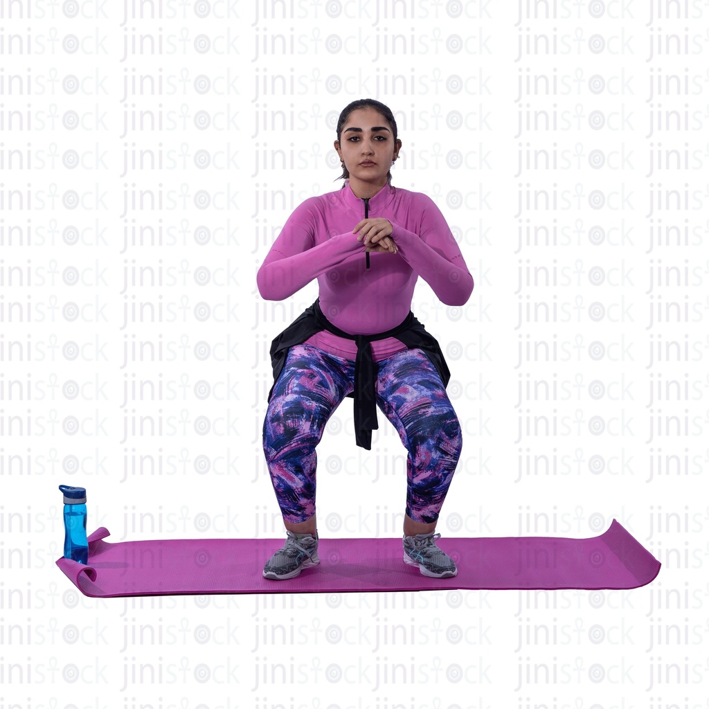 Young Egyptian woman exercising and performing a squat