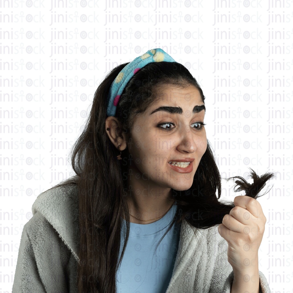 Egyptian woman looking at her hair with split ends