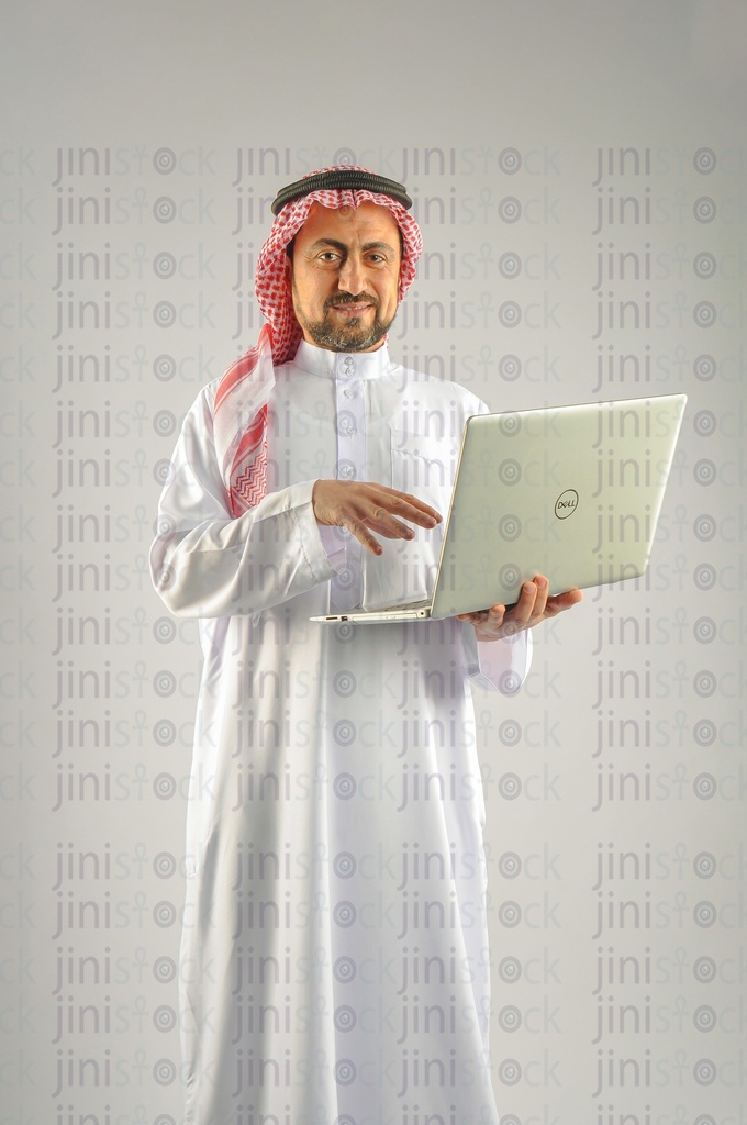 Khaliji, Saudi, Emirati, a man from the Gulf holding a laptop and working on it