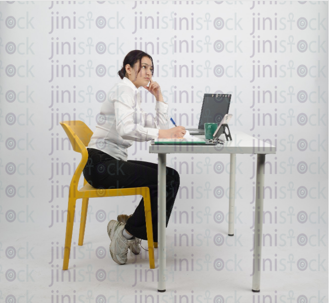 Woman working on laptop and thinking - looking up - stock image