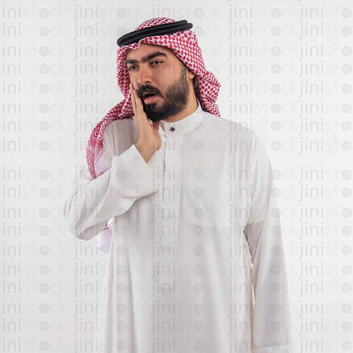 khaliji man with hand on checks stock image