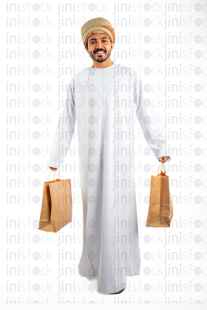 omani khaliji from gulf man carrying shopping bags and walking