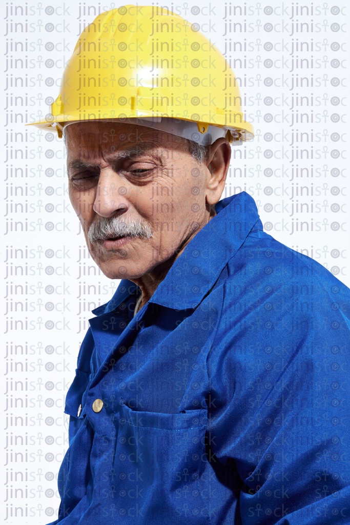 old male worker in blue suite and yellow cap sad