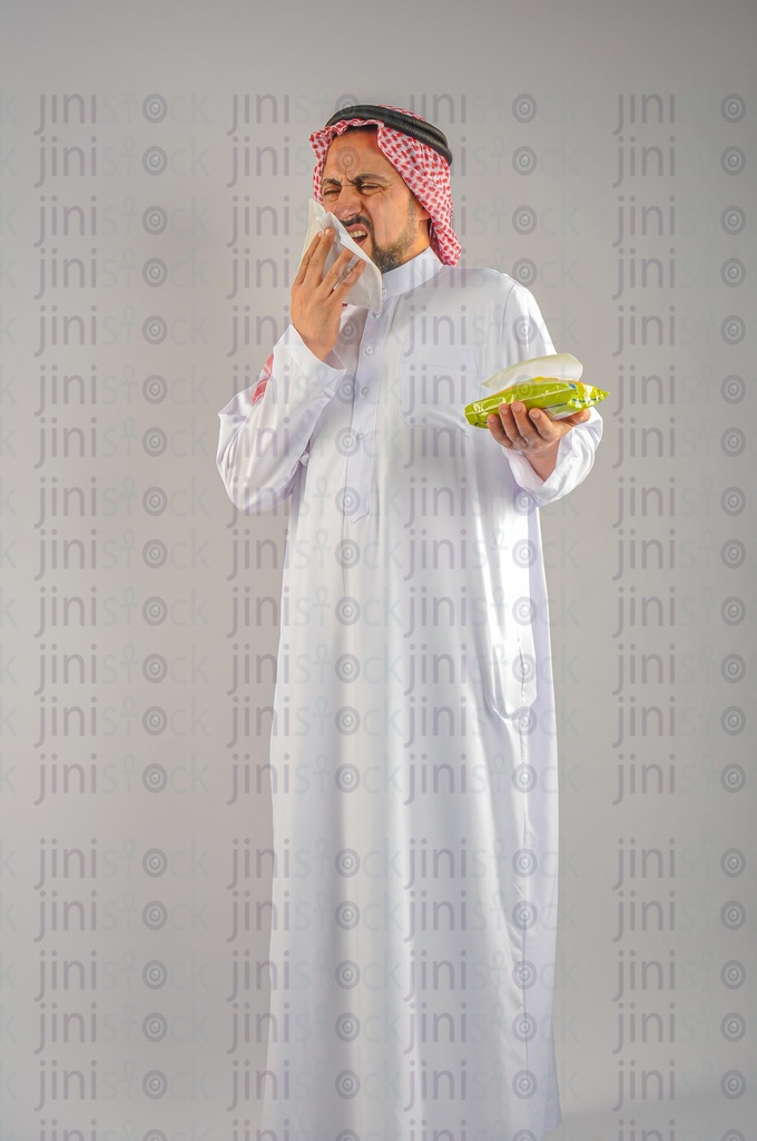 A Gulf man from Saudi Arabia or the UAE has flu and sneezing.