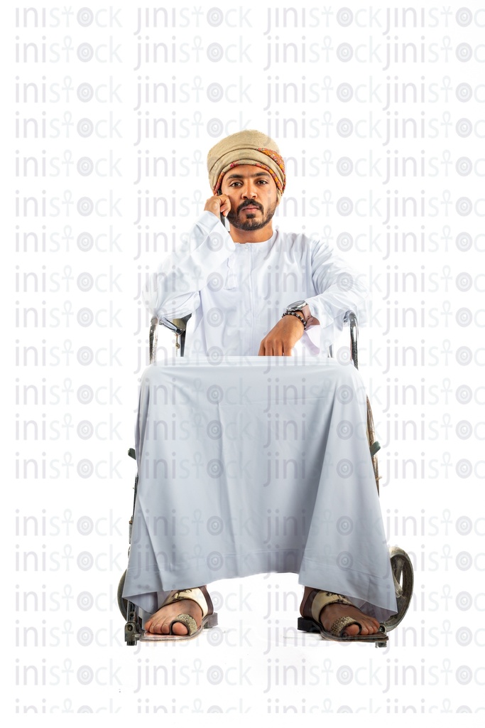 omani khaliji arab man from gulf on a wheelchair talking on the phone