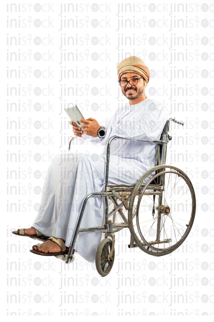 omani khaliji arab man from wheel chair working on his ipad