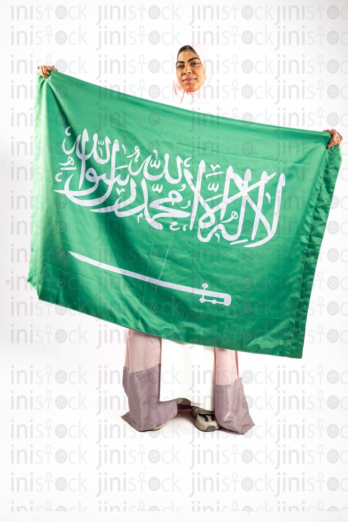 khaliji arab saudi woman from gulf carrying KSA flag