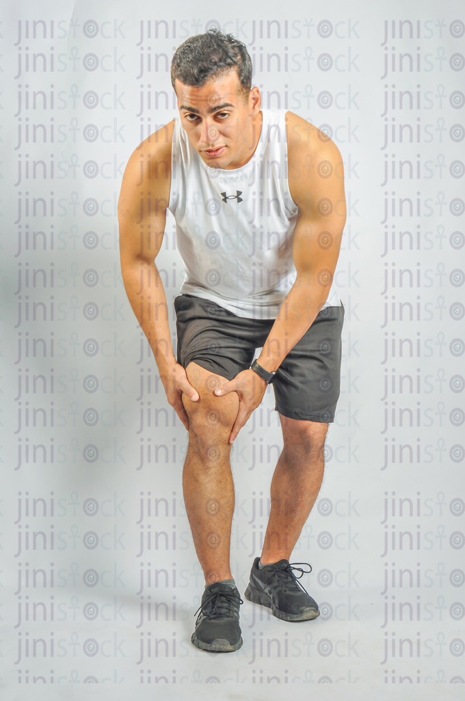 An athletic man has a leg or knee injury.