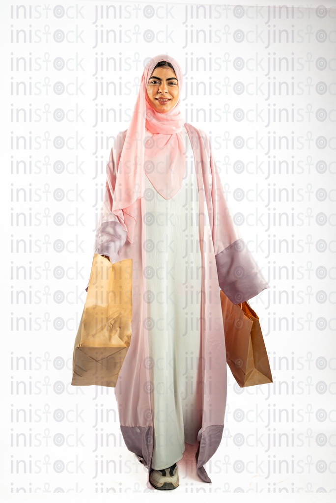 khaliji arab woman from gulf shopping and carrying bags