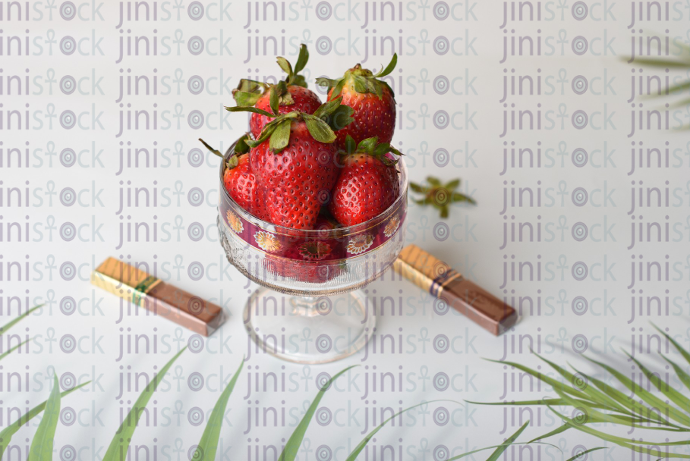 Strawberries in a glass cup - chocolate pieces - stock image