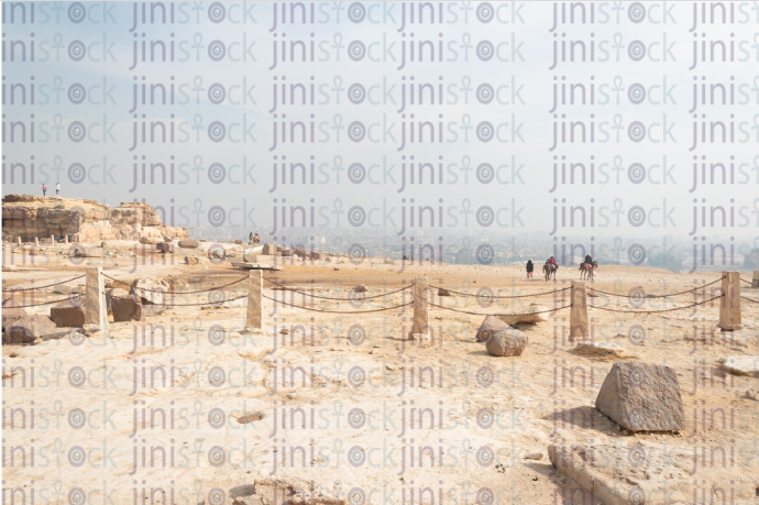 Two men riding horses in the pyramids - stock image