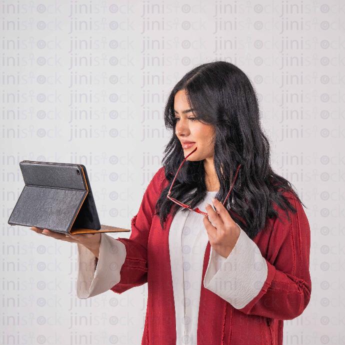 khaliji woman watching tablet stock image with high quality