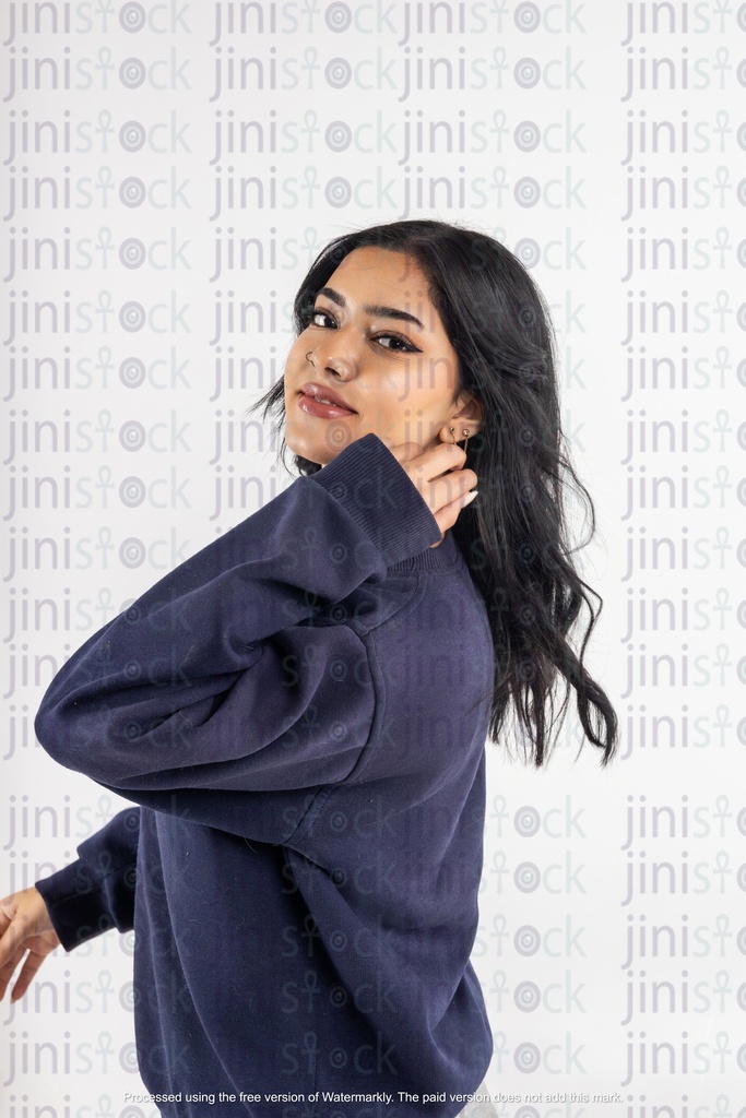 a stock image of a side Arabian woman with hands on hair on isolated background