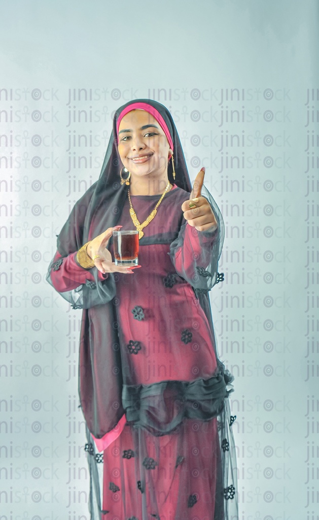 A Nubian Egyptian woman wearing a Nubian dress, a veil on her head, or an Egyptian farmer holding a cup of tea and a thumb up