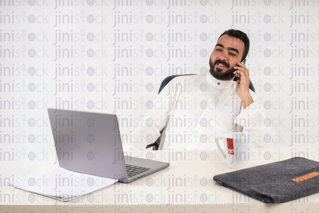 a stock image of a gulf business man working and talking on mobile