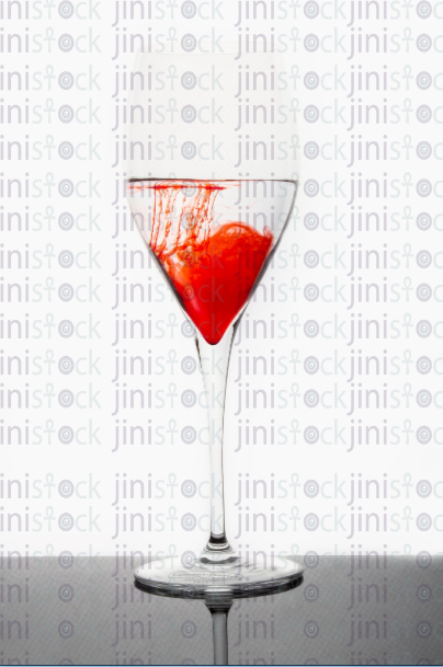 glass of water with red ink dissolving - stock image