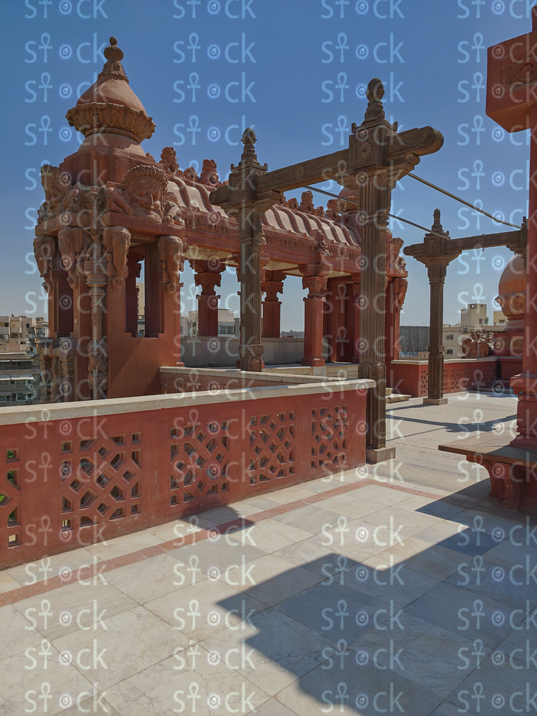 Sunlit arcade, shadows on pavement 