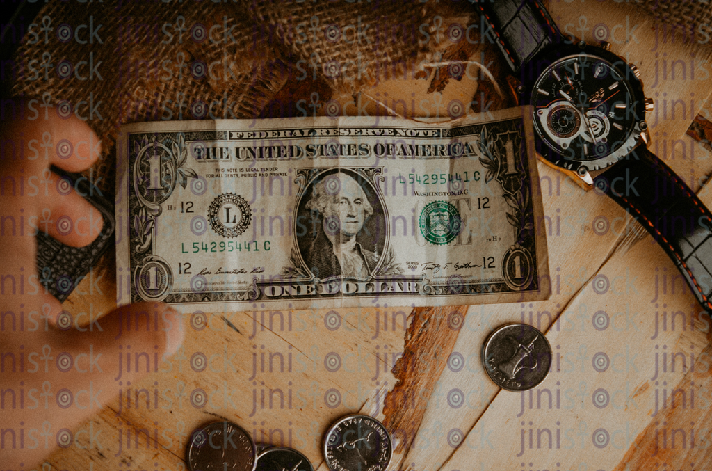 hand reaching for a dollar- Stock image