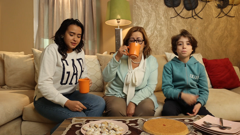 family eating khak and drinking tea