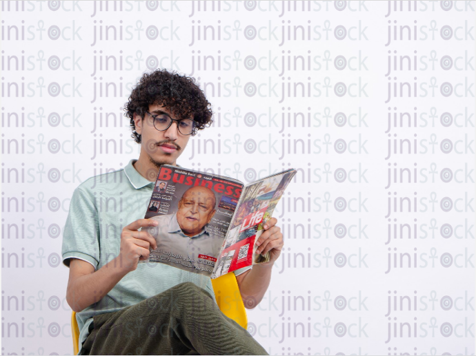 young man reading a magazine - stock image